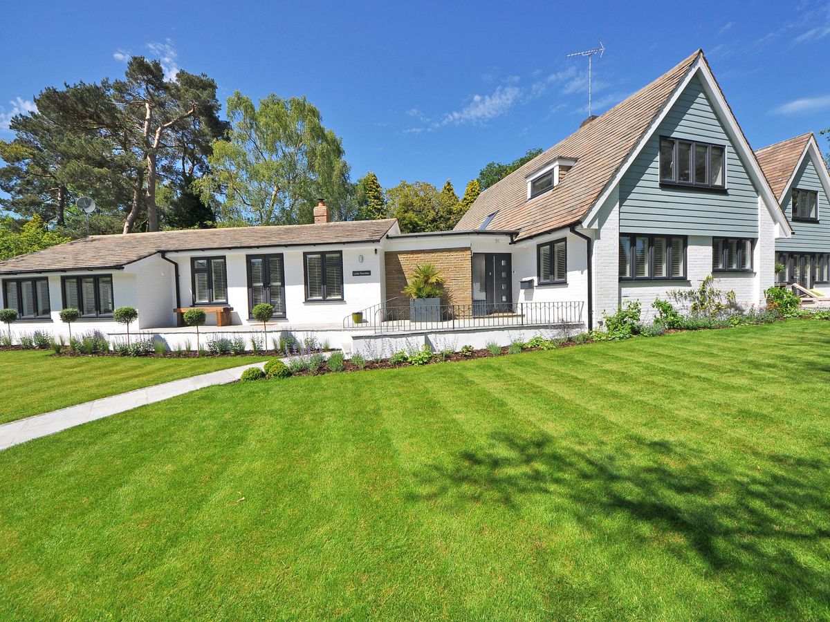 Landscaped residential yard with trees and fresh planting beds